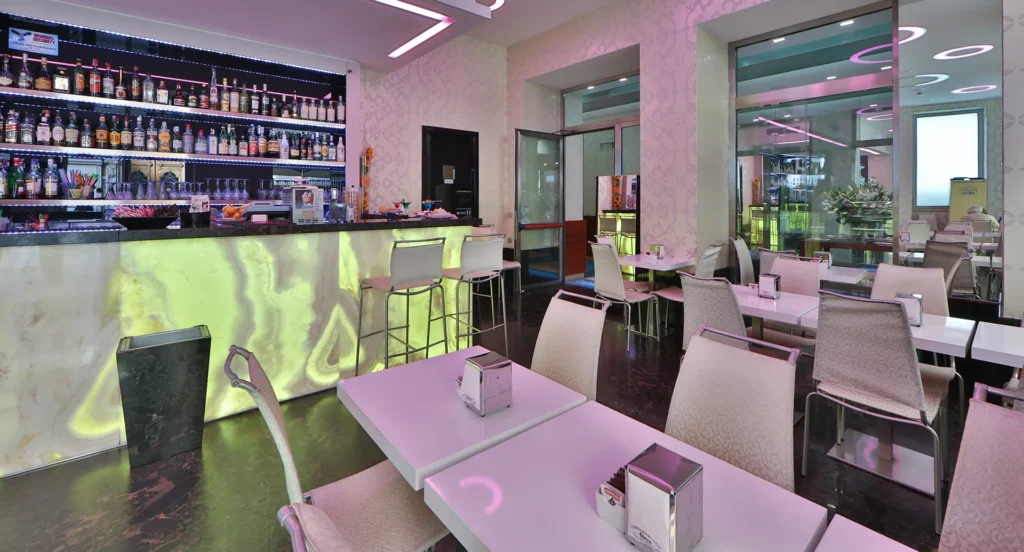 The image shows the bar with tables and chairs.