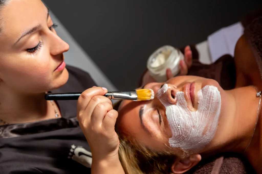 The image shows a girl having a facial treatment.