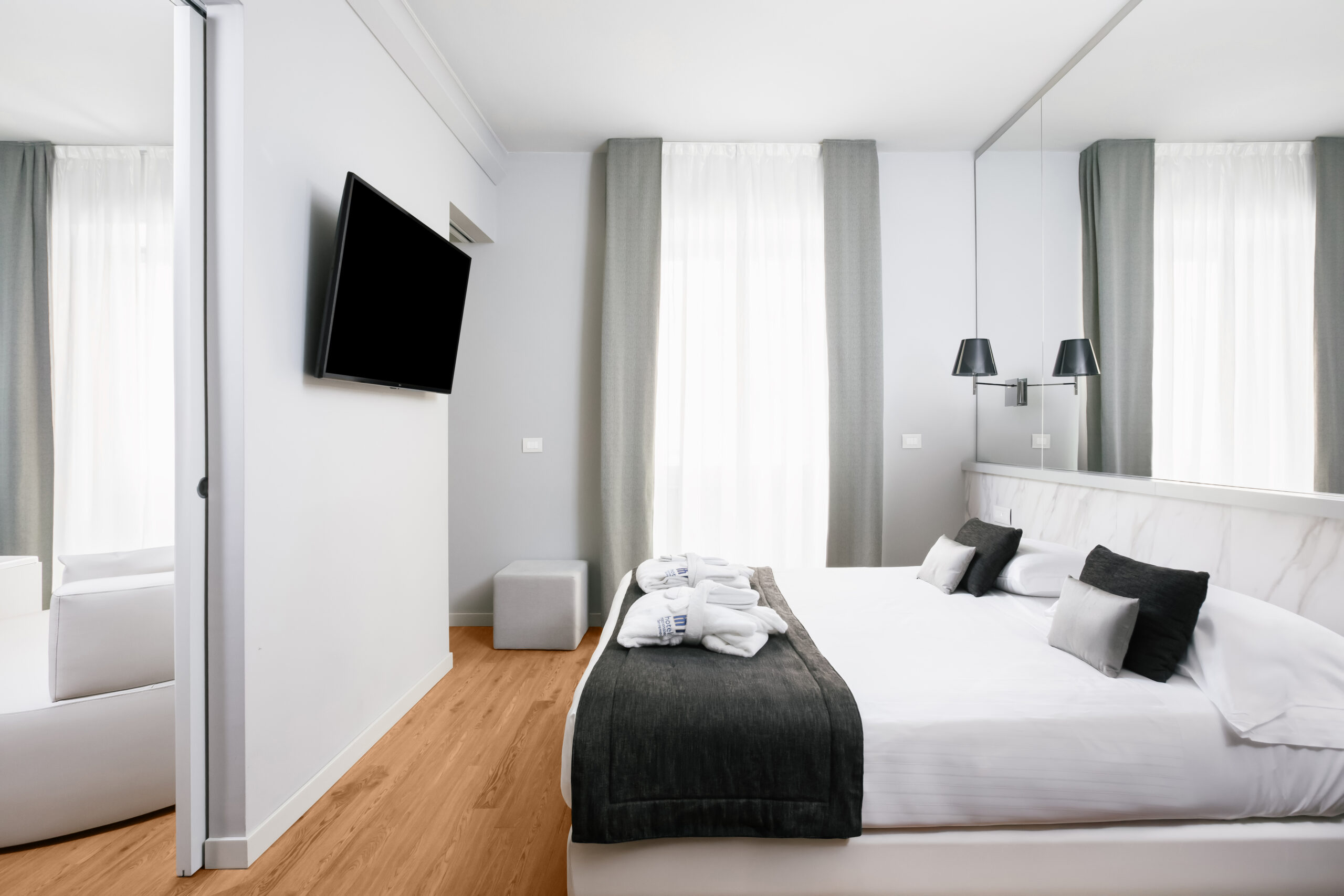 The image shows a room with a window and a double bed.