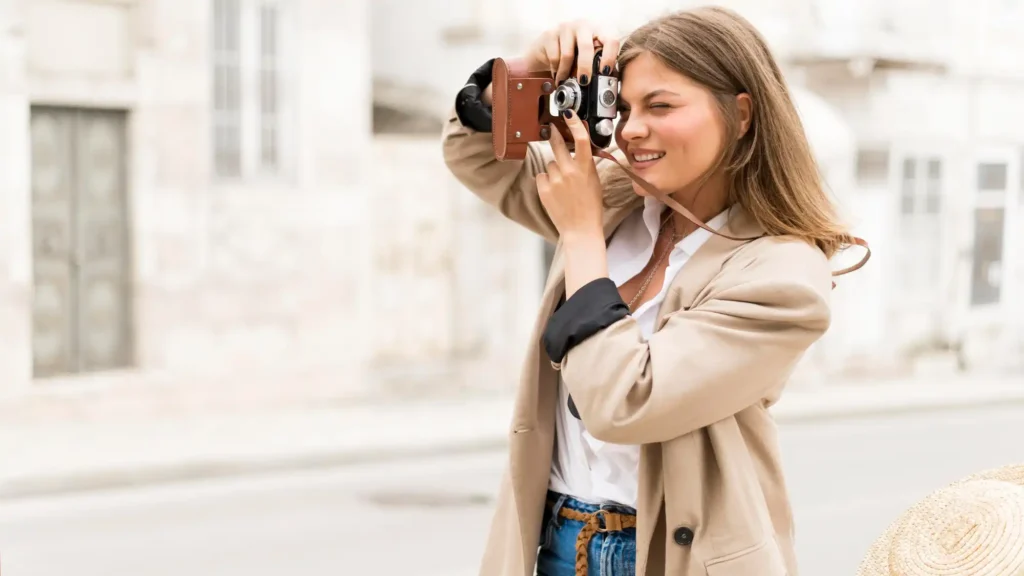 The image shows a girl holding a camera.